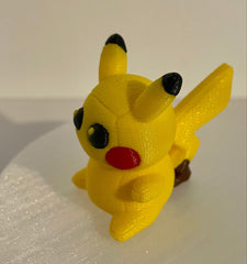 Handmade knitted-style 3D printed Pokémon-inspired electricity creature with textured filament, large black eyes, yellow  with brown accents on a lightening bolt tail, photographed from the side on a white background.