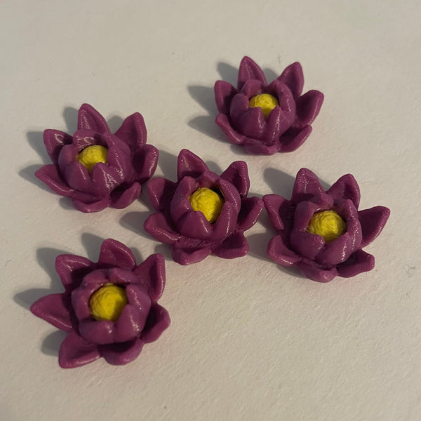 Purple flower-shaped objects with yellow centers on a white background.